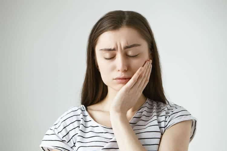lady suffering from teeth pain