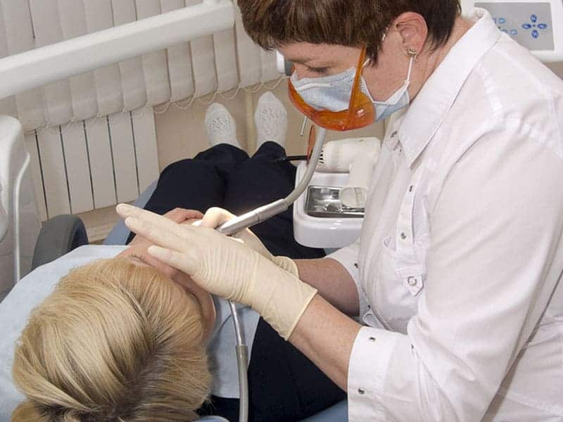 Dentist treating her patient